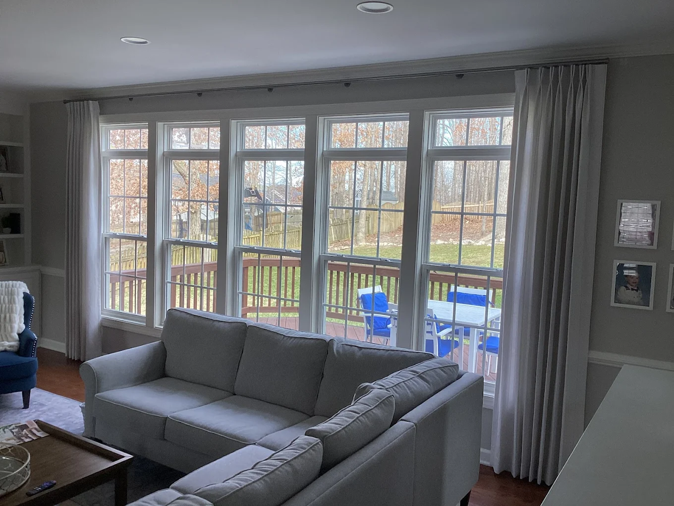 Tall windows with cream drapery