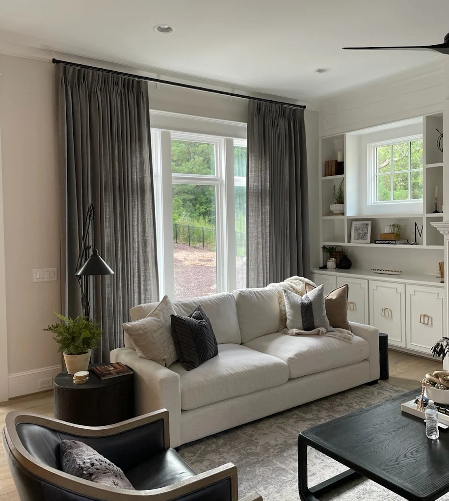 Wide window bank with gray drapery